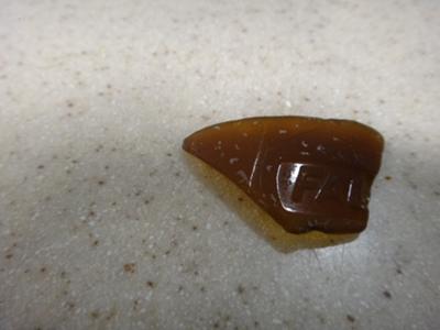 Identification. Brown sea glass with FAL....